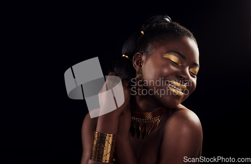 Image of Beauty, gold and black woman in studio for makeup, art and elegance against a black background. Rich, creative and African female model pose with jewelry for wealth, royal and luxury queen aesthetic