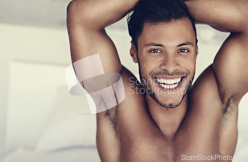 Image of Bedroom portrait, stretching and happy man with morning smile for wellness, start of new day and happiness after sleeping. Sleep health, wake up and face of healthy young person awake on home bed