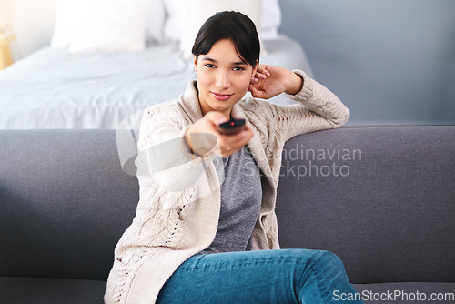 Image of Watching tv, portrait of happy woman with remote and in bedroom of their home. Entertainment or comfortable relaxation, news or television and cheerful female person streaming movie or series