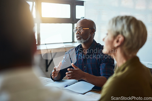 Image of Business people, meeting and leadership of black man in office, talking or speaking. Teamwork, ceo and senior African male professional brainstorming, collaboration or planning strategy in workplace.