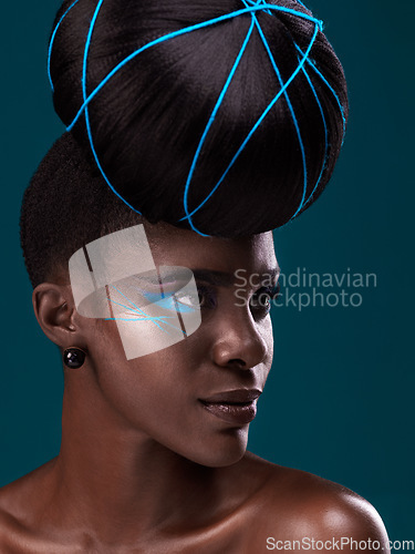 Image of Idea, fashion and hair care with a model black woman in studio on a blue background for beauty. Thinking, makeup and cosmetics with an attractive young female person at a salon for a trendy hairstyle