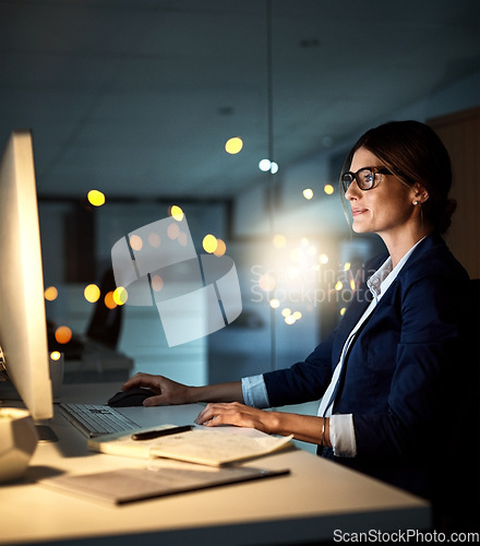 Image of Businesswoman, desktop and focus at night or employee in the office or reading emails on bokeh. Corporate, dark and female manager or contemplate or research on pc in the evening and at workplace