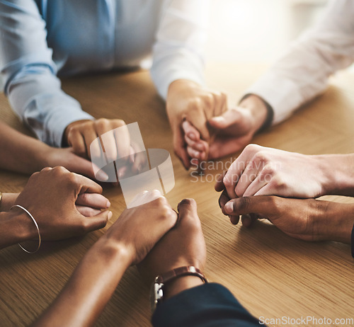 Image of Trust circle, therapy and people holding hands by a wood table at a group counseling or psychology session. Gratitude, spiritual and friends praying together for religion, community and connection.