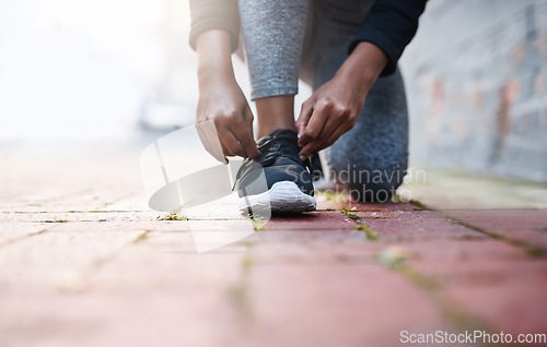 Image of Exercise, tie and and laces of female athlete or running shoes or hands and healthy woman with knee on the floor. Training, work out and foot or lady runner starts fitness routine in closeup