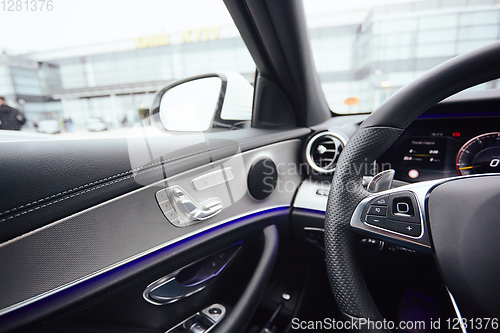 Image of Control buttons on steering wheel. Car interior.