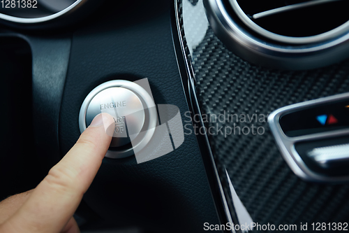 Image of Car driver starting the engine. Shallow dof.