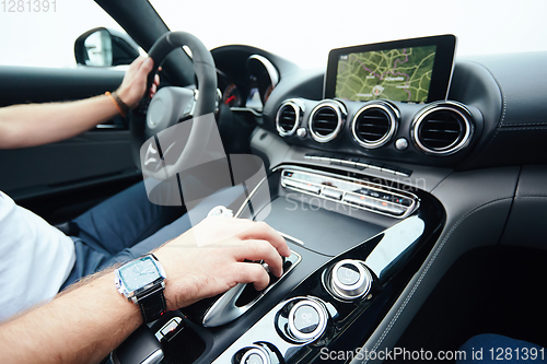 Image of hand on automatic gear shift, Man hand shifting an automatic car