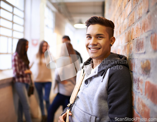 Image of Education, smile and portrait of student in college hallway for studying, learning and scholarship. Future, happy and knowledge with man leaning against wall for university, academy and campus