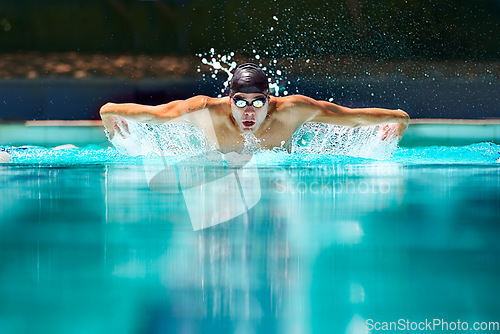 Image of Fitness, sport and training with man in swimming pool for competition, workout and energy. Strong, water splash and cardio with male swimmer and practice for athlete, championship and race at gala