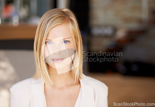 Image of Face, young serious woman at her office and in a blurred background. Portrait of confident or proud person, corporate manager or worker and closeup of female professional with focus in Denmark