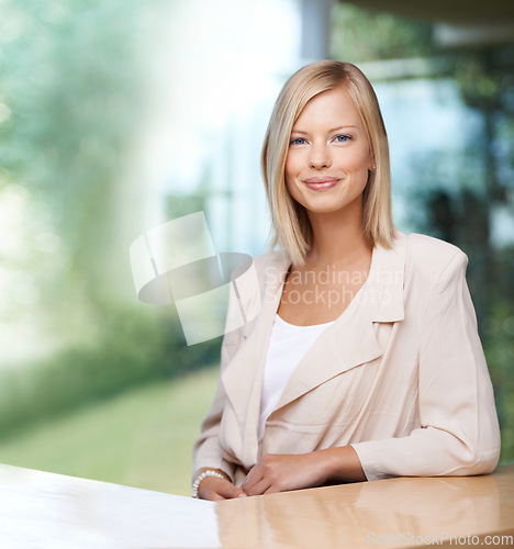 Image of Portrait, mockup and professional with a business woman at a desk in her office for company vision. Confident, happy and success with a young female employee looking ambitious while sitting at work