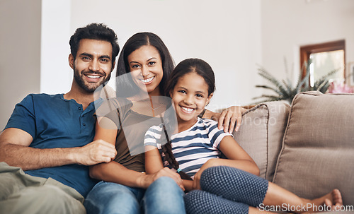 Image of Happy family, smile and portrait on the sofa to relax, bond and sitting comfortable. Content, quality time and a mother, father and girl child on the living room couch for happiness, love and care