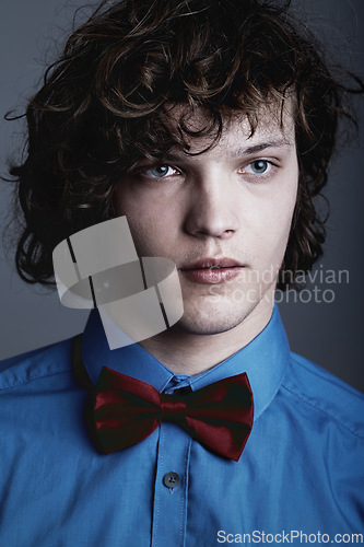 Image of Fashion, face of man in shirt and bow tie on studio background with aesthetic geek style and serious expression. Elegant beauty, formal and unique nerd clothes on gen z male model on grey backdrop.