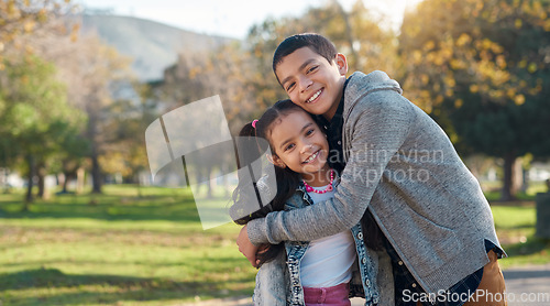 Image of Park, hug and portrait of brother and sister enjoying summer day for bonding, quality time and playing. Family, children and happy siblings hugging, embrace and loving in nature for relaxing together