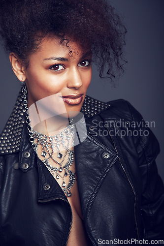 Image of Fashion, style and beauty portrait of woman in studio for trendy clothes, leather jacket or jewellery. Face of African female model with makeup, cosmetic and punk or rock aesthetic on grey background