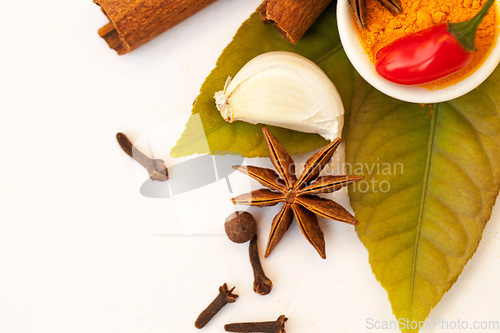 Image of Spices, herbs flat lay of organic ingredients for cooking or cinnamon or garlic or taste in food and on a white background. Nutrition, diet and coriander for seasoning and natural chilli in studio