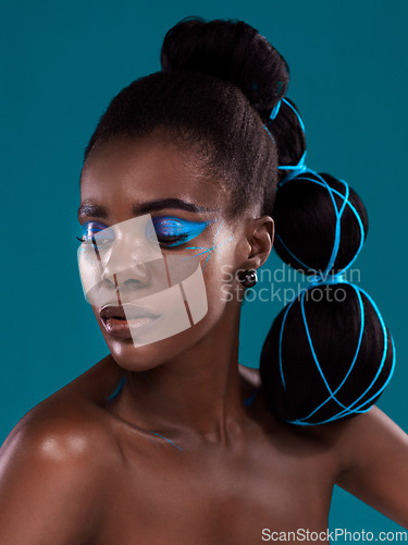 Image of Thinking, beauty and makeup with a model black woman in studio on a blue background for hair or trendy fashion. Face, cosmetics and idea with an attractive young female person posing for haircare