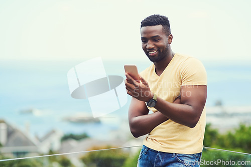 Image of Outdoor, space and black man on phone or social media, app or technology for email communication, mockup and blue sky. Smartphone, online networking or internet conversation on screen with smile