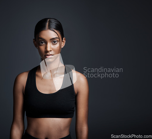 Image of Portrait, serious and Indian woman with mockup, exercise and workout goal on dark studio background. Face, female person pr athlete with fitness, healthy girl or wellness with progress or development