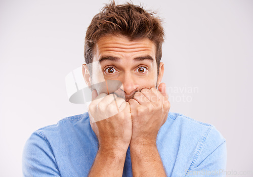 Image of Portrait, bite nails and man with anxiety, stress and worried with guy isolated on a grey studio background. Face, male person and human with depression, mental health problem and scared with doubt