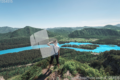 Image of Woman taking photo in mountain