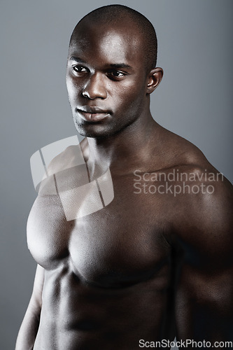 Image of Art, aesthetic beauty and muscle, black man on grey background with fitness, strong and serious body builder in Africa. Health, wellness and bodybuilder or male model isolated on studio backdrop.
