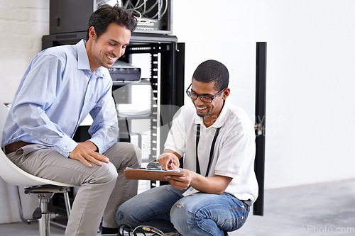 Image of Server room, it support and clipboard with a technician talking to a business man about cyber security. Network, database and contract with a male engineer chatting about information technology
