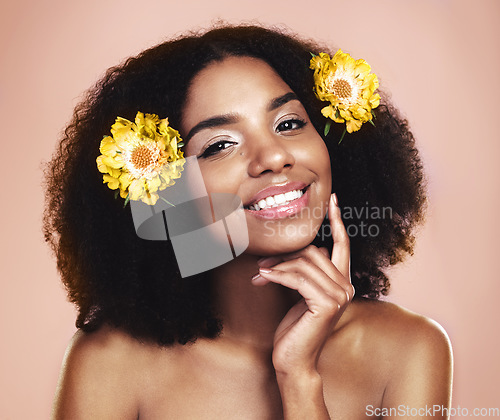 Image of Portrait face of happy woman, afro and flowers in studio background for beauty, floral aesthetic and shine. African model, natural skincare and daisy plants in hair for makeup, cosmetics and perfume