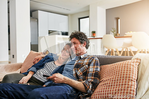 Image of Happy couple, relax and watching tv on living room sofa for news, cable show and media connection at home. Mature man, woman and hug with television remote, video subscription and streaming platform