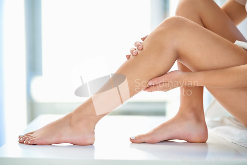 Image of Skincare, soft and legs of a woman after waxing, grooming and cleaning in a bathroom. Beauty, moisturize and a person touching a leg after shaving or removing body hair for a treatment at home