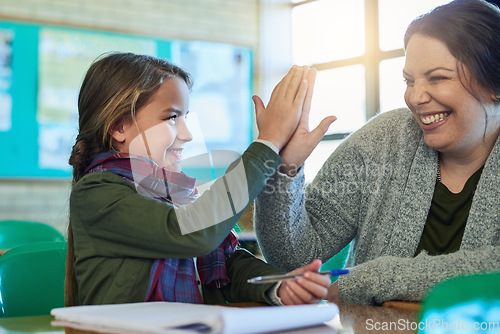 Image of High five, student and teacher happy to help with work, study and learning math in classroom and girl, education, book and pen. Child, success and achievement in school or helping, woman and support