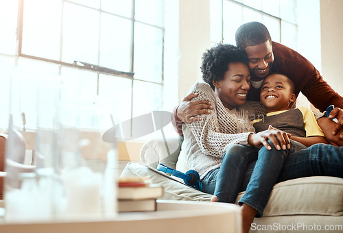 Image of Smile, relax and family hugging on a sofa together in the living room of their modern house. Happy, love and African mother and father bonding, embracing and resting with their boy child at home.