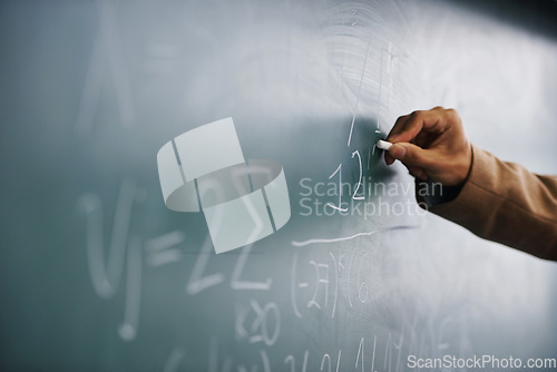 Image of Closeup, hand and writing on a blackboard, formula and teaching with system, process and geek. Zoom, person and teacher with chalk, learning and maths equation with calculation, research or education