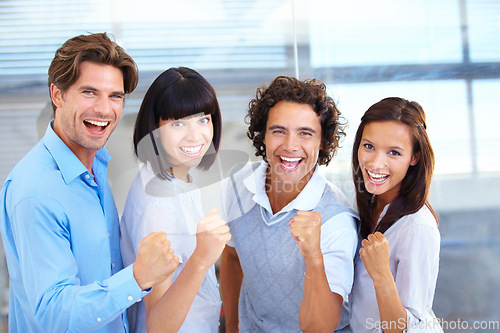 Image of Business people, portrait smile and fist in celebration for winning, teamwork or success at the office. Happy and excited employees standing together in happiness for victory, win or team promotion