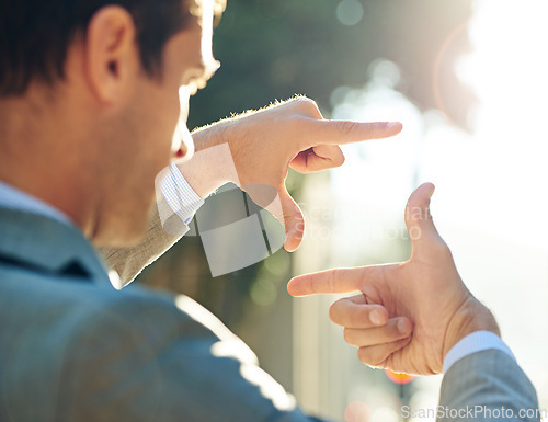 Image of Hand, frame and business man in city for vision, focus and thinking with mockup. Inspiration, planning and idea with male employee and finger gesture in outdoors for freedom, motivation and insight