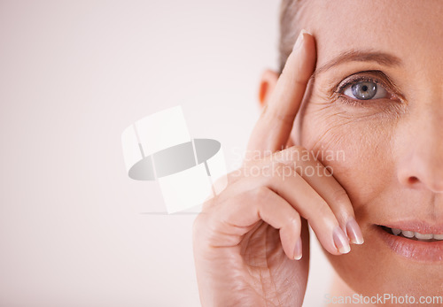 Image of Eye, portrait and senior woman skincare on mockup or zoom on face in studio backdrop. Eyecare for wellness, beauty or aesthetic model happy about cosmetic makeup, manicure and health on background