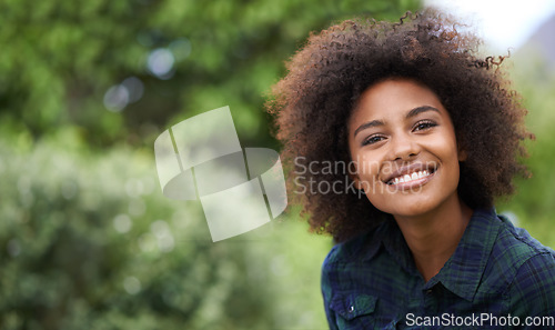 Image of Black woman outdoor in portrait, smile in nature with positive mindset with mockup space. Headshot of happy female person, young and carefree with curly afro hairstyle and happiness at the park