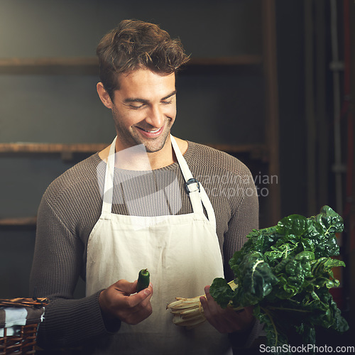 Image of Food, happy man with vegetables and chef in kitchen in his home. Healthy or nutrition diet with spinach, ingredients or recipe and smiling male person with apron prepare green salad at his house