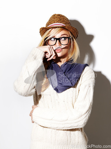 Image of Hipster, isolated portrait and girl with moustache on index finger, nerd glasses and fun pose on studio white background. Young woman, modern fashion and mustache joke or goofy, weird and finger