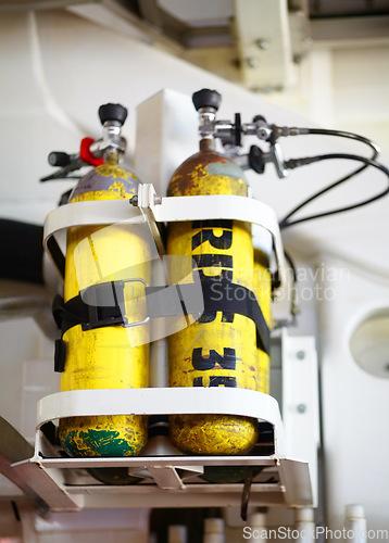 Image of Oxygen tanks, metal and cylinders of emergency equipment, storage and fire department gear in important workplace, safety and medical supplies. Background, yellow and air container or rescue object