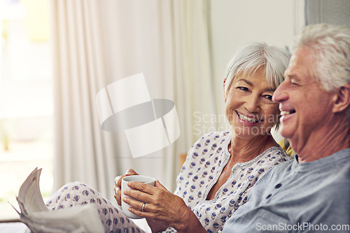 Image of Coffee, newspaper and a senior couple in bed, enjoying retirement in their home in the morning. Tea, reading or love with a happy mature man and woman in the bedroom together to relax while bonding