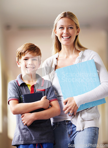 Image of Portrait, teacher and boy walking, hallway and books with education, knowledge and happiness. Face, female person and student with an educator, male child and kid in a lobby, corridor and learning