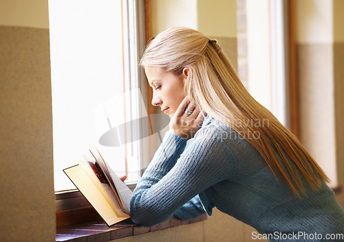 Image of Woman, young student and reading a book or in school hallway or campus and window for exams. Lady, university learner and knowledge or literature or classroom and project for test for information