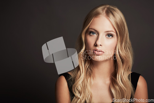 Image of Portrait, face and beauty of a woman with makeup, cosmetics and hair shine in studio. Headshot of a female aesthetic model with skin glow, luxury skincare and mockup space on a dark background