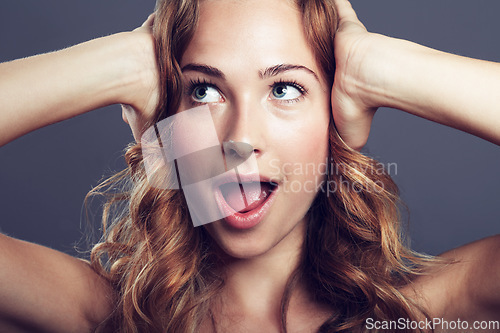 Image of Surprise, thinking and face of an excited woman with a smile isolated on a dark background in a studio. Wow, idea and a young female model with expression of shock from makeup and cosmetics ideas