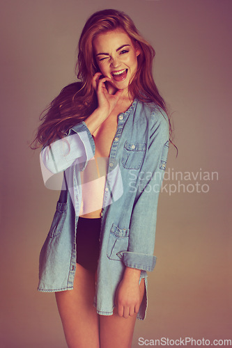 Image of Woman, excited wink and portrait with casual fashion and smile in a studio. Sexy, flirty and female model with happiness and style with isolated blurred background feeling confident and empowerment