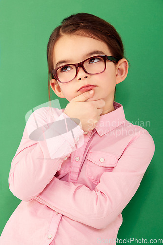 Image of Thinking, ideas and girl with focus, green screen and thoughts against a studio background. Kid, female child and young person with wonder, opportunity and ponder with facial expression and future