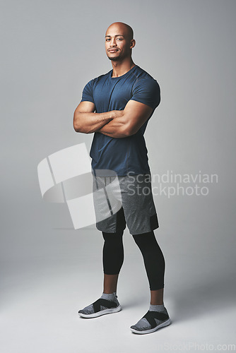 Image of Arms crossed, fitness and portrait of man isolated on studio background for healthy body and workout. Confident, happy and strong athlete, bodybuilder or African person with exercise for sports power