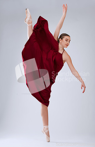 Image of Ballet, talent and woman in studio for training, creative routine and ready for performance, show or artist with movement on grey studio background. Dancer, ballerina or female performer with balance
