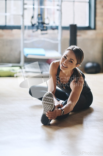 Image of Portrait, smile and woman stretching, fitness and workout goal with balance, stress relief and happiness. Face, female person or athlete on the floor, stretch legs and training for wellness or health